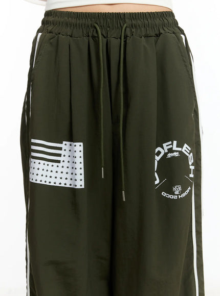 graphic-wide-leg-track-pants-cm511