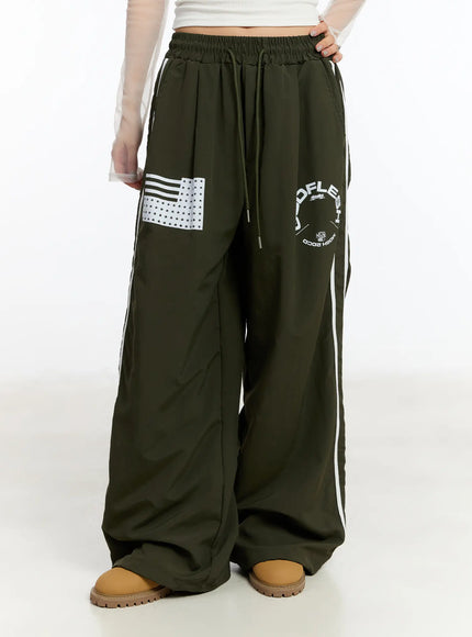 graphic-wide-leg-track-pants-cm511